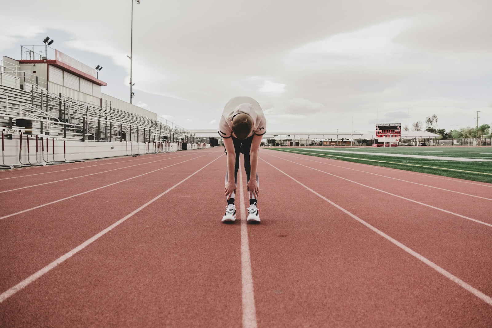 Runner stretching on the track before a training session.